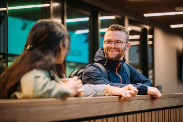 two students standing chatting